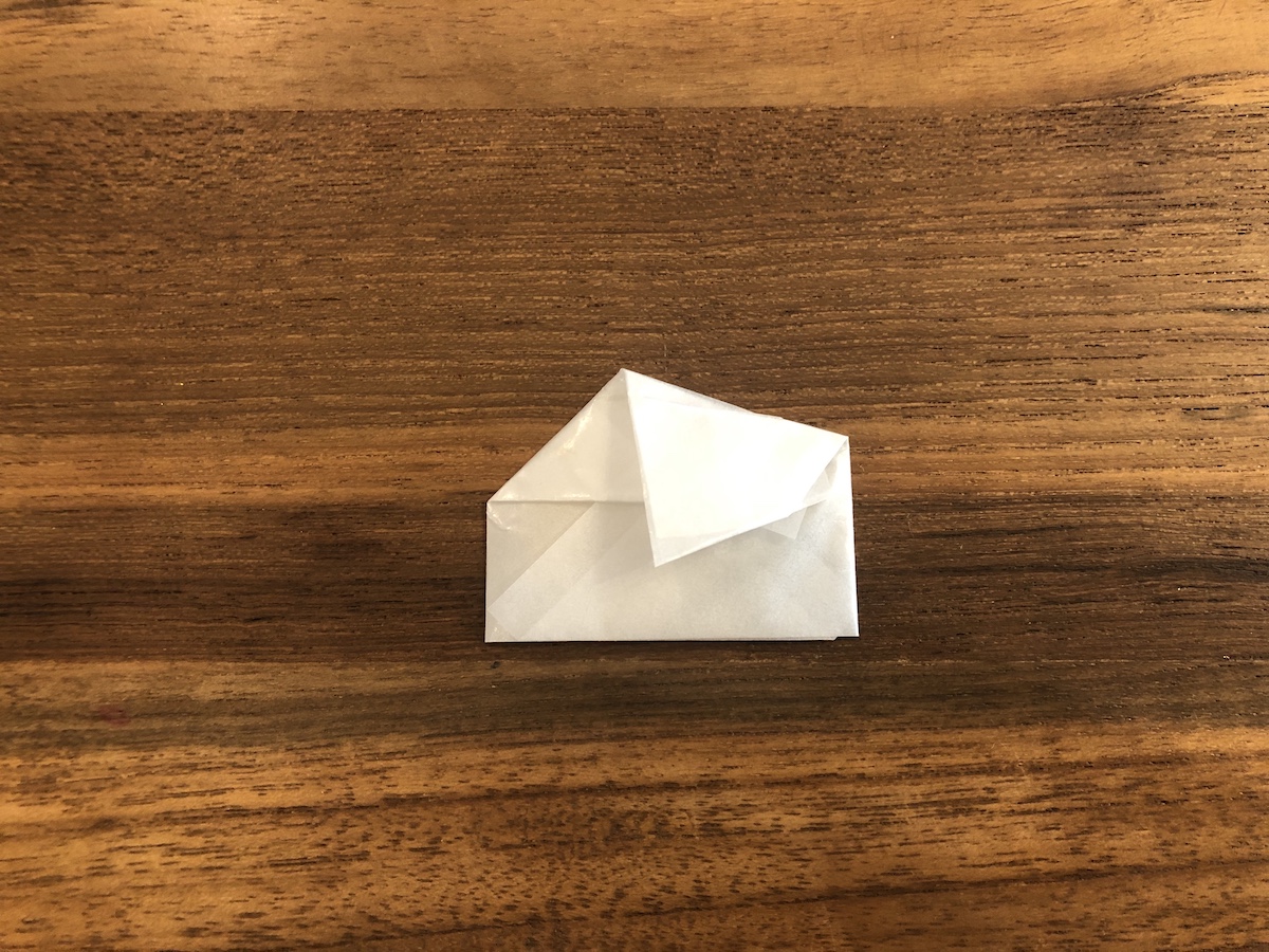 薬包紙の包み方　⑤右上の出っ張った部分を左斜め下に向かって折る